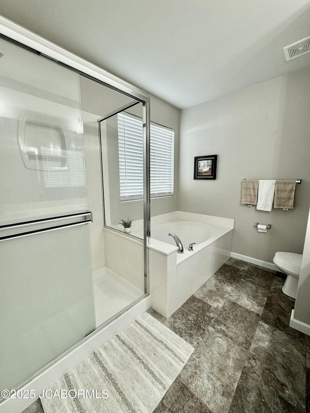 bathroom featuring a garden tub, toilet, visible vents, baseboards, and a shower stall