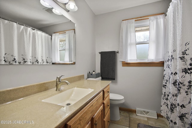 bathroom with toilet, baseboards, visible vents, and vanity