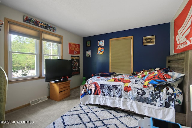 carpeted bedroom featuring baseboards and visible vents