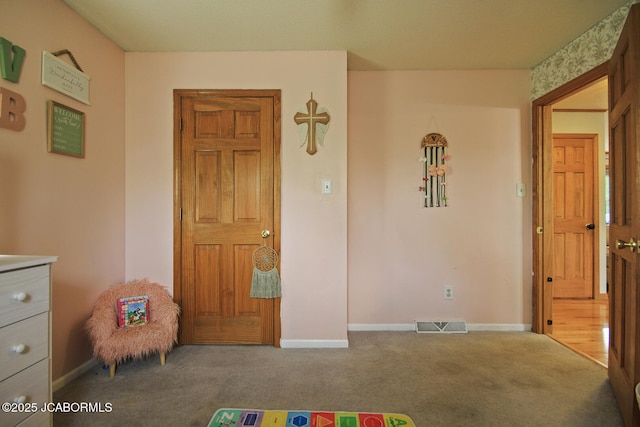 recreation room featuring baseboards, visible vents, and carpet