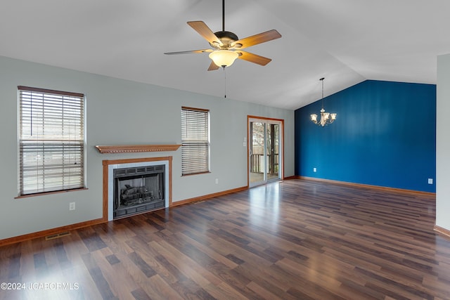 unfurnished living room with ceiling fan with notable chandelier, dark hardwood / wood-style flooring, and lofted ceiling