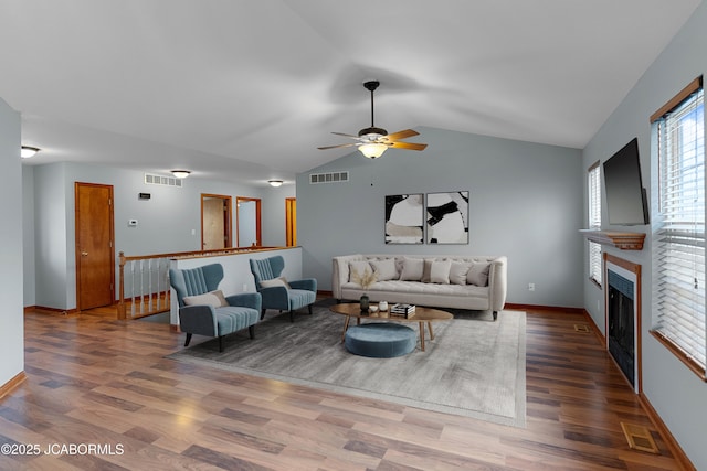 living room featuring ceiling fan, lofted ceiling, and hardwood / wood-style flooring