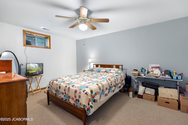 carpeted bedroom featuring a ceiling fan and visible vents