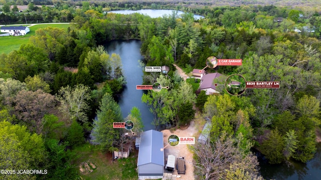 aerial view with a water view and a wooded view