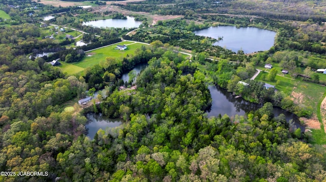 aerial view with a water view and a forest view
