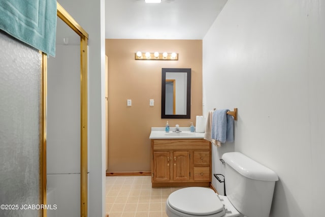 full bathroom with vanity, baseboards, an enclosed shower, and toilet