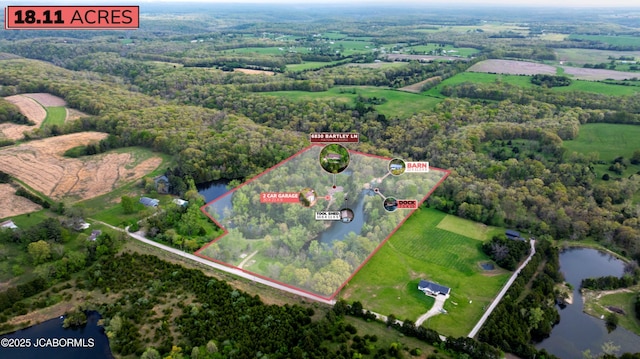 drone / aerial view featuring a water view and a rural view