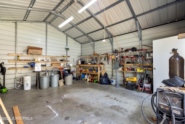 garage with a workshop area and metal wall
