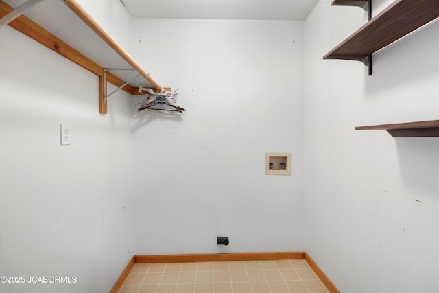 washroom with laundry area, hookup for a washing machine, and baseboards