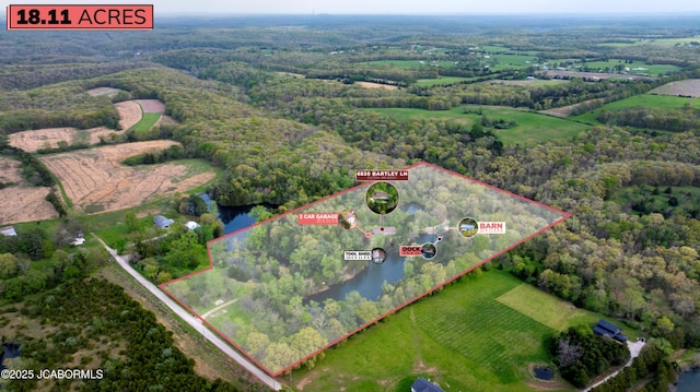 drone / aerial view featuring a water view, a rural view, and a forest view