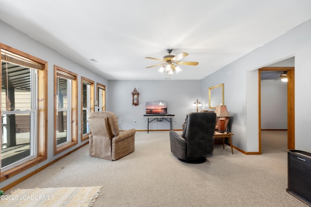 sitting room with carpet floors, a ceiling fan, and baseboards