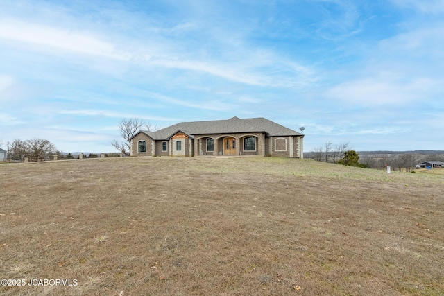 french country inspired facade with a front lawn