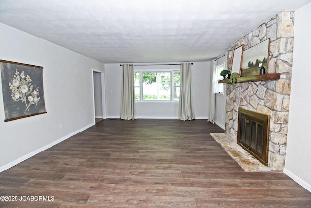164 Turn Back Now Trl, Linn, MO 65051 - unfurnished living room with a stone fireplace, baseboards, and wood finished floors