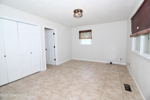 164 Turn Back Now Trl, Linn, MO 65051 - unfurnished bedroom with a closet, baseboards, and light tile patterned floors