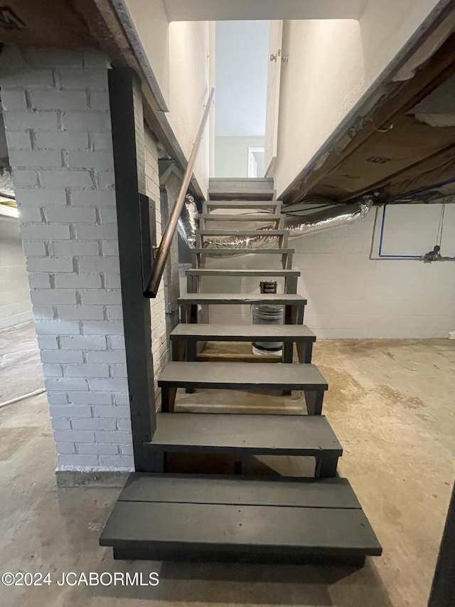 stairs with concrete flooring