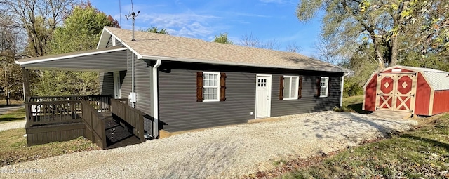 view of side of home with a storage shed