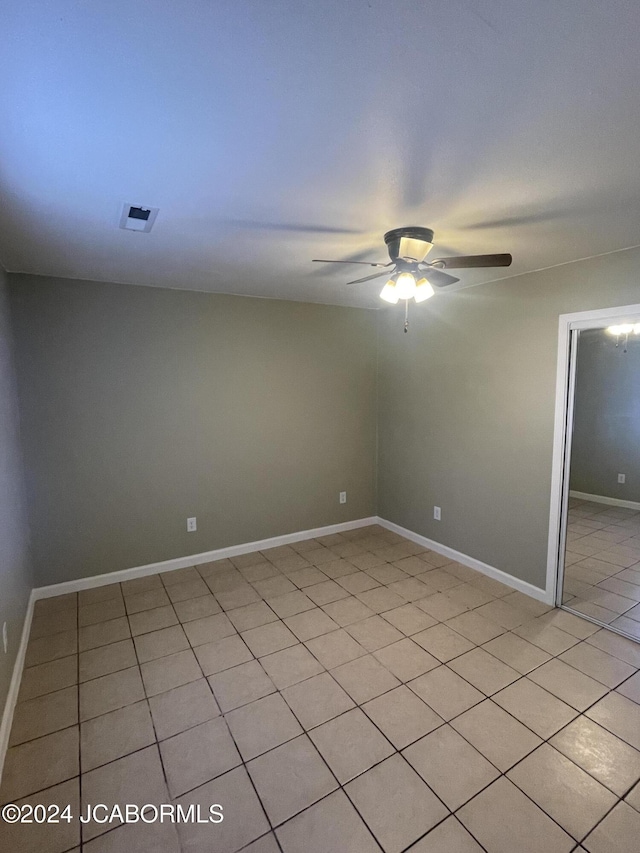 unfurnished room featuring light tile patterned floors and ceiling fan