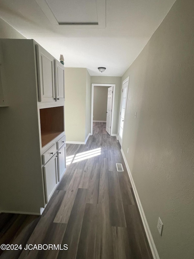 hallway with dark wood-type flooring