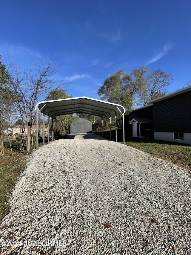 view of parking / parking lot featuring a carport