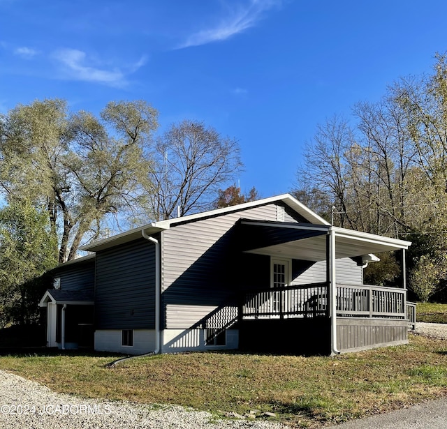 view of side of home with a yard