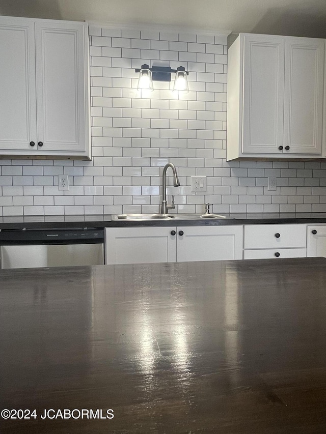 kitchen with tasteful backsplash and white cabinets