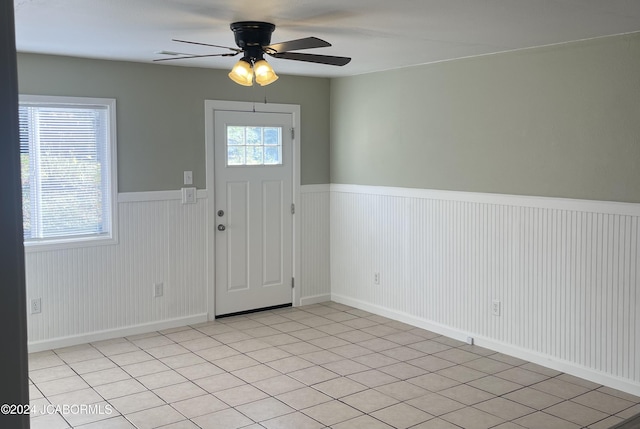 entryway with ceiling fan and light tile patterned floors