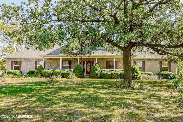 ranch-style house with covered porch and a front lawn