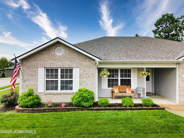 5112 Melissa Dr, Columbia, MO 65202 - view of front of property featuring a porch, a front lawn, brick siding, and a shingled roof