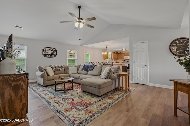 5112 Melissa Dr, Columbia, MO 65202 - living area featuring a ceiling fan, light wood-type flooring, a chandelier, and high vaulted ceiling