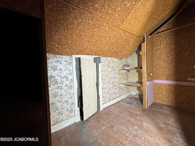 204 Havana St, Jefferson City, MO 65109 - unfurnished room featuring hardwood / wood-style floors, wallpapered walls, and lofted ceiling