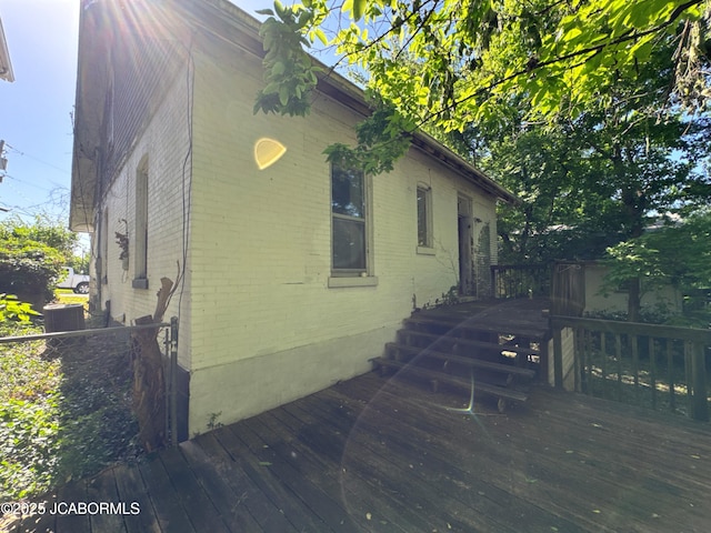 204 Havana St, Jefferson City, MO 65109 - view of side of property with brick siding, a deck, and central air condition unit