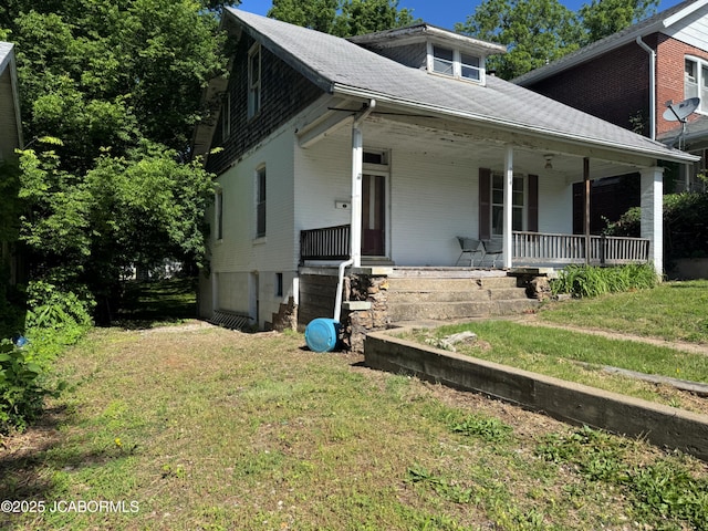 204 Havana St, Jefferson City, MO 65109 - view of front facade featuring a front lawn, a porch, brick siding, and roof with shingles