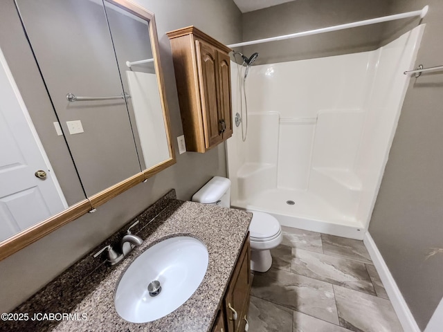 full bath with baseboards, toilet, vanity, and walk in shower