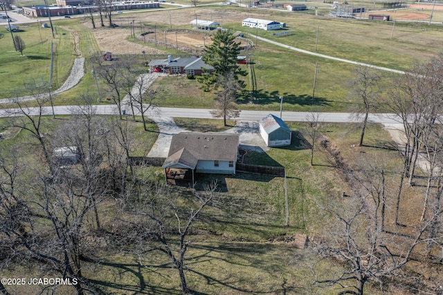 birds eye view of property with a rural view