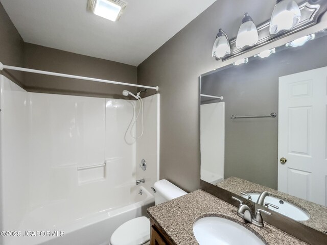 full bath featuring toilet, vanity, and bathtub / shower combination