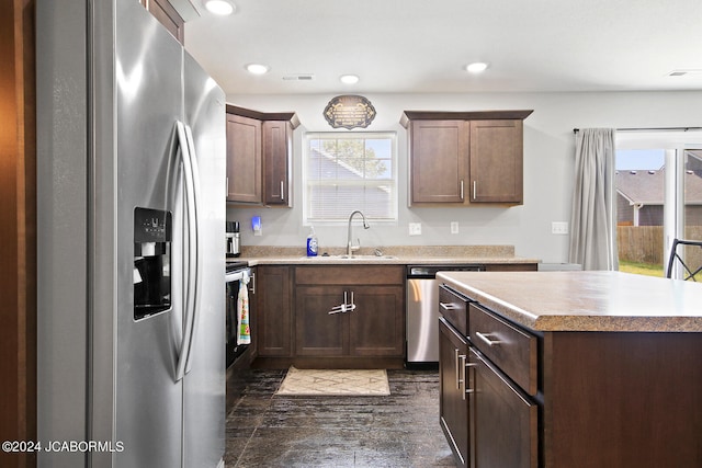 kitchen with stainless steel appliances, recessed lighting, light countertops, visible vents, and a sink