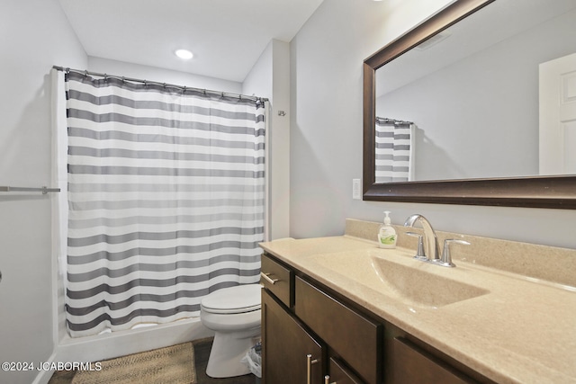 bathroom with recessed lighting, a shower with shower curtain, vanity, and toilet