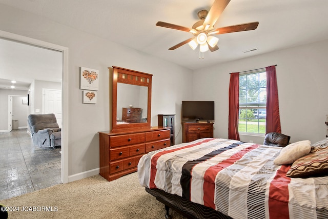 bedroom featuring a ceiling fan, visible vents, and baseboards