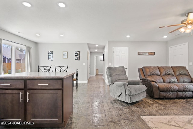 living area featuring a ceiling fan, baseboards, hardwood / wood-style floors, and recessed lighting