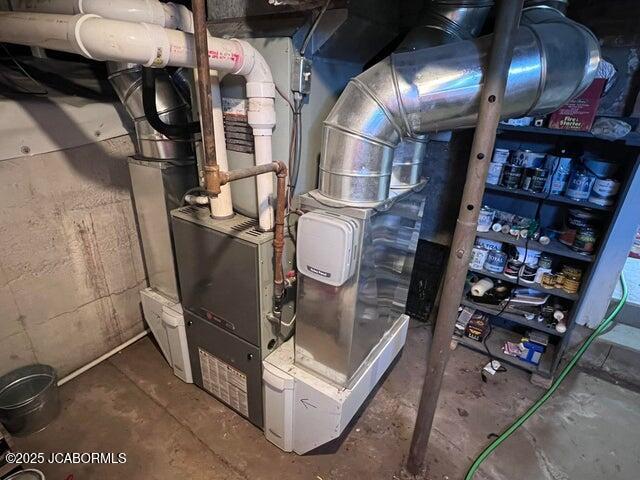 utility room featuring heating unit