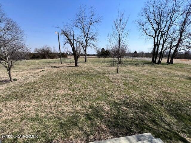view of grassy yard with a view of rural / pastoral area