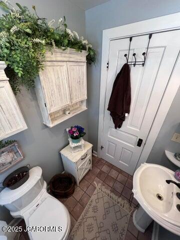 bathroom with a sink, tile patterned floors, and toilet