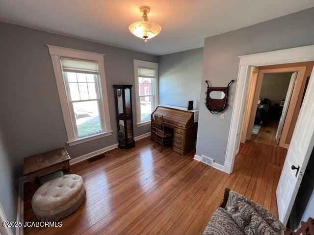 bedroom with baseboards and wood-type flooring