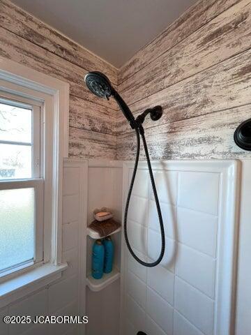 bathroom view of wood walls and tiled shower