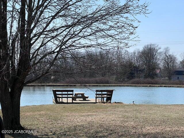 dock featuring a water view and a lawn