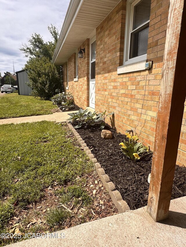 713 Lincoln St, Linn, MO 65051 - view of home's exterior featuring brick siding and a yard