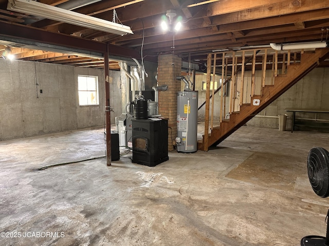 713 Lincoln St, Linn, MO 65051 - below grade area featuring water heater, a wood stove, and stairway