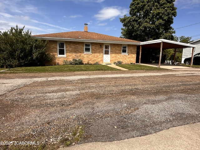 713 Lincoln St, Linn, MO 65051 - view of front of property with a chimney, a front lawn, brick siding, and driveway