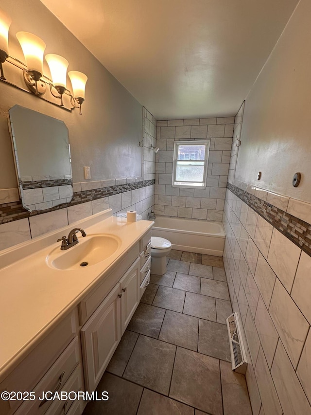 713 Lincoln St, Linn, MO 65051 - full bath with tile walls, toilet, vanity, bathtub / shower combination, and tile patterned flooring