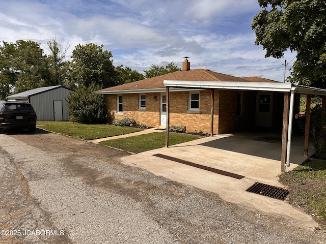 713 Lincoln St, Linn, MO 65051 - view of front of house with a chimney, a front lawn, concrete driveway, brick siding, and an attached carport